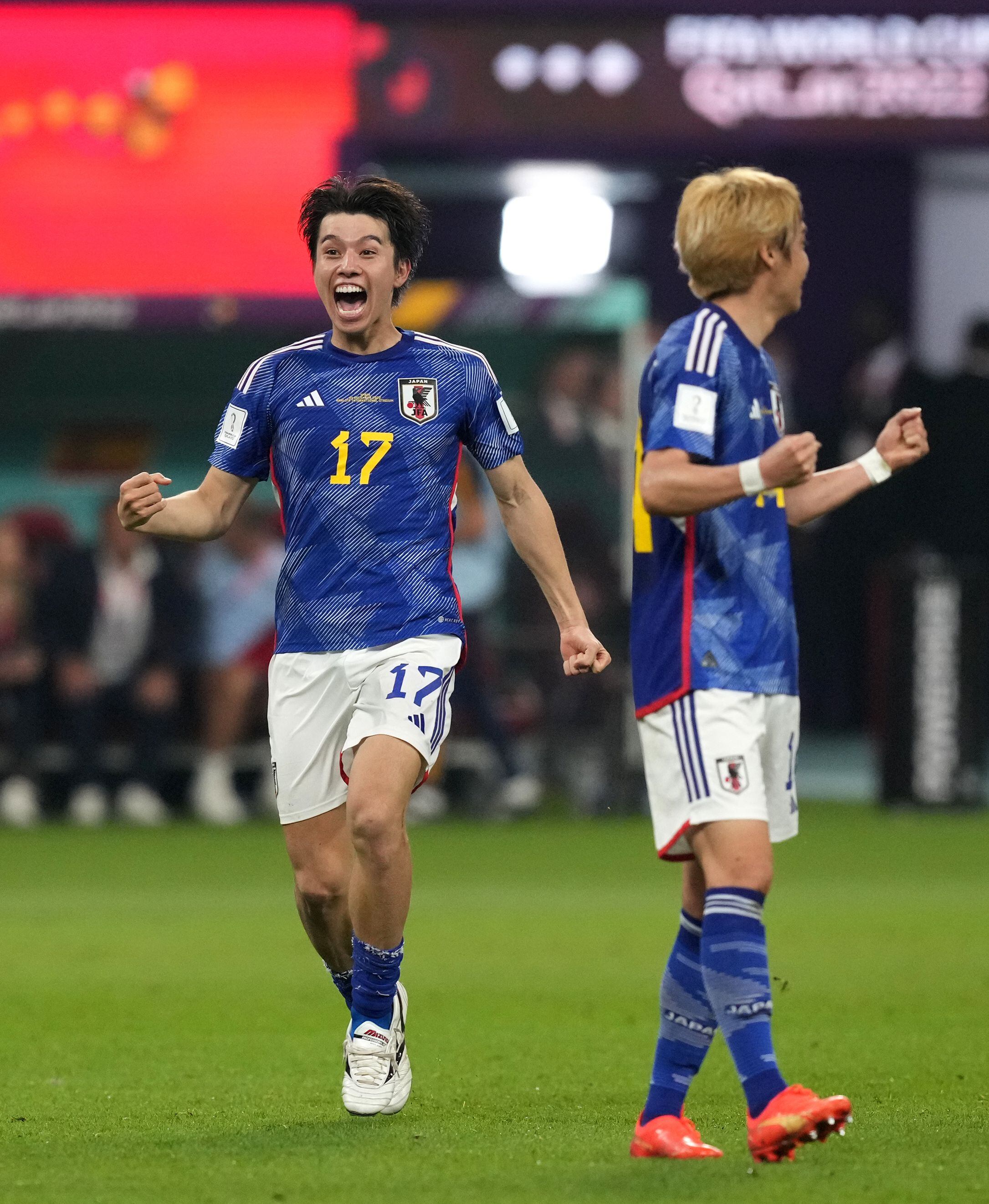 Ritsu Doan (L) of Japan vies for the ball with Alejandro Balde of