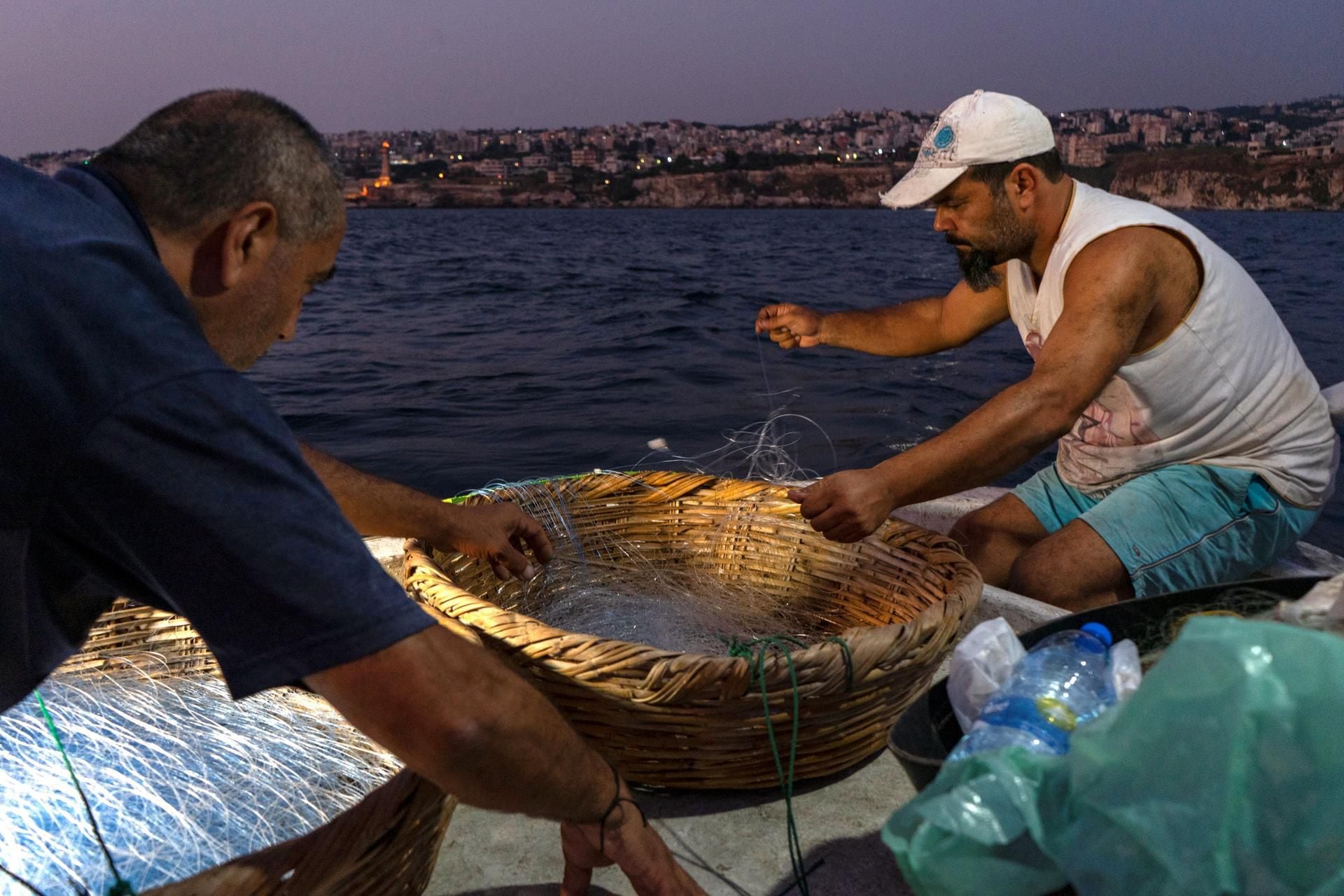 The Man Carry Fish Basket at Fishing Market. LONG Editorial